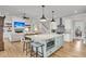 Open-concept kitchen with an expansive island, integrated microwave, and seamless flow into the living area at 2269 Hartfords Bluff Cir, Mount Pleasant, SC 29466
