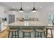 Well-appointed kitchen featuring a large island, light blue accents, and modern stainless steel appliances at 2269 Hartfords Bluff Cir, Mount Pleasant, SC 29466