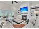Spacious living room with fireplace, built-in shelves, large TV and access to outdoor space at 2269 Hartfords Bluff Cir, Mount Pleasant, SC 29466