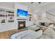 Cozy living room with fireplace, built-in bookshelves, mounted tv, and plush sofa at 2269 Hartfords Bluff Cir, Mount Pleasant, SC 29466