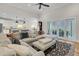 Open-concept living room with a comfortable sectional sofa and views of the patio and kitchen at 2269 Hartfords Bluff Cir, Mount Pleasant, SC 29466