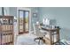 Bright home office with a wooden desk, balcony and ample space at 2269 Hartfords Bluff Cir, Mount Pleasant, SC 29466