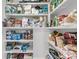 Organized pantry shelves stocked with food, snacks, and household supplies at 2269 Hartfords Bluff Cir, Mount Pleasant, SC 29466