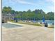 Community pool with lounge chairs, tables, umbrellas, and more at 2269 Hartfords Bluff Cir, Mount Pleasant, SC 29466