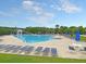 Community pool with lounge chairs and umbrellas at 2269 Hartfords Bluff Cir, Mount Pleasant, SC 29466