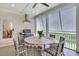 Outdoor dining area on screened porch, featuring grill, exhaust, and comfortable seating around wood table at 2269 Hartfords Bluff Cir, Mount Pleasant, SC 29466