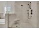 Modern glass enclosed shower with a rainfall shower head and tile surround at 2269 Hartfords Bluff Cir, Mount Pleasant, SC 29466