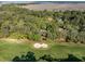 An aerial shot of a lush golf course neighborhood, complete with sand traps and surrounding marshland at 2355 Andell Way, Seabrook Island, SC 29455