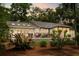 A backyard deck with furniture and a grill, surrounded by lush foliage at 2355 Andell Way, Seabrook Island, SC 29455