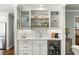 Stylish bar area featuring custom cabinetry, shelving, and a wine refrigerator at 2355 Andell Way, Seabrook Island, SC 29455
