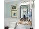 Well-lit bathroom with wainscotting, modern fixtures and a granite countertop vanity at 2355 Andell Way, Seabrook Island, SC 29455