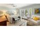 Cozy bedroom with a bed, bench, bedside tables, and doors leading to an outdoor patio at 2355 Andell Way, Seabrook Island, SC 29455