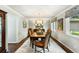 Formal dining room featuring a wood table, decorative chairs, a chandelier, and large windows at 2355 Andell Way, Seabrook Island, SC 29455
