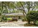 Traditional home nestled among mature trees with lush greenery and updated front stairs at 2355 Andell Way, Seabrook Island, SC 29455