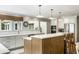 Open kitchen with stone countertops, stainless appliances, and modern light fixtures at 2355 Andell Way, Seabrook Island, SC 29455