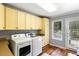 Bright laundry room with washer, dryer, utility sink and ample cabinet storage at 2355 Andell Way, Seabrook Island, SC 29455