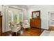 Comfortable living room with hardwood floors, two armchairs, a dresser, and large windows for natural light at 2355 Andell Way, Seabrook Island, SC 29455