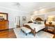 Bright main bedroom with hardwood floors, bedside tables, and a bed with a cushioned bench at 2355 Andell Way, Seabrook Island, SC 29455