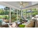 Relaxing sunroom with wicker furniture and views of the lush backyard at 2355 Andell Way, Seabrook Island, SC 29455