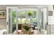 Bright sunroom featuring wicker furniture and views of the landscaped backyard at 2355 Andell Way, Seabrook Island, SC 29455