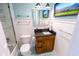Bathroom with updated features showcasing wainscoting, a vanity with sink, a toilet and a tub with shower at 24 Archdale St, Charleston, SC 29401