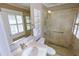 Beautiful bathroom boasts a glass shower, shuttered window, vanity, and marble countertop at 24 Archdale St, Charleston, SC 29401