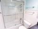 Bright bathroom featuring a bathtub with a glass door shower and white subway tile at 24 Archdale St, Charleston, SC 29401