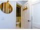 Cozy powder room with dark floral wallpaper, white wainscoting, and a decorative wooden coat rack at 24 Archdale St, Charleston, SC 29401