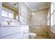 Modern bathroom features a glass shower, marble countertop, and custom shelving at 24 Archdale St, Charleston, SC 29401