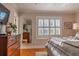 A charming bedroom with a view of a shuttered window, a mirror, and chest of drawers at 24 Archdale St, Charleston, SC 29401