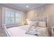 Comfortable bedroom has a white bed with stylish bedding, a side table, and decorative wall art creating a cozy retreat at 24 Archdale St, Charleston, SC 29401