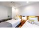 Well-lit bedroom with twin beds features modern decor, ceiling fan, and a shared nightstand for convenience at 24 Archdale St, Charleston, SC 29401