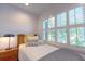 Comfortable bedroom featuring a cozy bed with decorative pillows, a nightstand, and natural light streaming through the window at 24 Archdale St, Charleston, SC 29401
