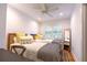 Bright bedroom offering two twin beds with stylish bedding, a ceiling fan, and a full-length mirror at 24 Archdale St, Charleston, SC 29401