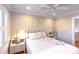 Inviting bedroom features a comfortable bed with stylish accents, a ceiling fan, and bright natural light from the window at 24 Archdale St, Charleston, SC 29401