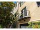 Charming townhouse featuring a cute balcony, garage, and well-maintained landscaping at 24 Archdale St, Charleston, SC 29401