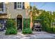 Charming home featuring a black door with beautiful garden and a private golf cart on a brick driveway at 24 Archdale St, Charleston, SC 29401