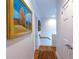 Hallway featuring hardwood floors, tasteful artwork on the walls, and access to the stairway creating a welcoming space at 24 Archdale St, Charleston, SC 29401