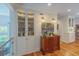 Hallway features wood floors, display cabinet with glass doors, wooden credenza, and stylish lighting at 24 Archdale St, Charleston, SC 29401