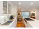 Open kitchen flows into the dining area, showcasing bright white cabinets and marble countertops at 24 Archdale St, Charleston, SC 29401