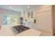 Bright eat-in kitchen with marble countertops, stainless steel appliances, island cooktop, and balcony access at 24 Archdale St, Charleston, SC 29401