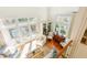 Bright open-concept living room with hardwood floors, white walls, and large windows at 24 Archdale St, Charleston, SC 29401