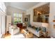 Bright living room with hardwood floors, fireplace, and a view into an adjacent room at 24 Archdale St, Charleston, SC 29401