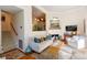 Bright living room with hardwood floors, fireplace, and a view into an adjacent room at 24 Archdale St, Charleston, SC 29401
