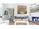 Sunlit living room with hardwood floors, comfortable seating, and a partial view of the upper floor at 24 Archdale St, Charleston, SC 29401
