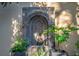 Elegant wall-mounted fountain surrounded by lush greenery in a serene outdoor setting at 24 Archdale St, Charleston, SC 29401