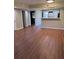 Bright and spacious living area with laminate flooring, leading to a kitchen, a bedroom and laundry area at 2502 Hidden Cove Dr # 2502, Moncks Corner, SC 29461