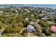 Aerial view of a coastal community featuring homes surrounded by lush greenery and water views at 2802 Ion Ave, Sullivans Island, SC 29482