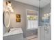 Bright bathroom featuring marble countertop, glass shower, and natural light from the window at 2802 Ion Ave, Sullivans Island, SC 29482