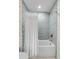 Bathroom featuring blue tile, white tub, and a shower with white shower curtain at 2802 Ion Ave, Sullivans Island, SC 29482